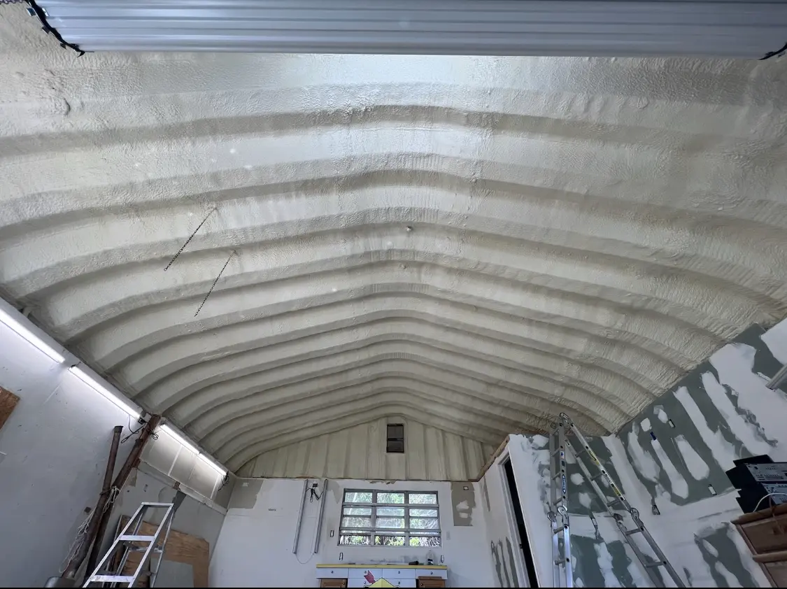 Spray polyurethane foam applied to the underside of a metal roof deck in Louisville